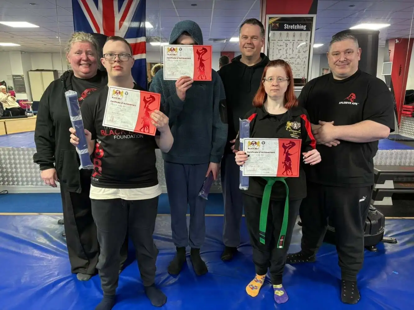 Students holding grading certificates at The Black Belt Foundation Chorley