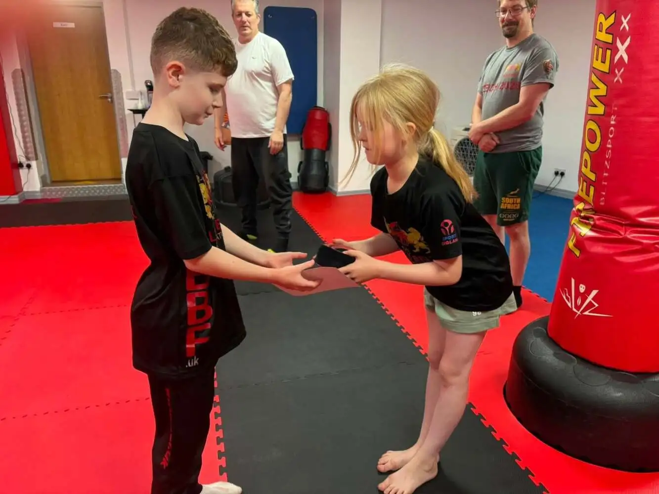 Junior students bowing to each other at The Black Belt Foundation Chorley