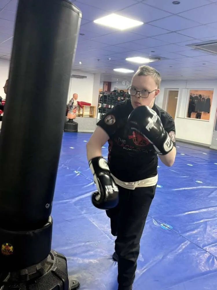 Adult student training on a heavy bag at The Black Belt Foundation Chorley